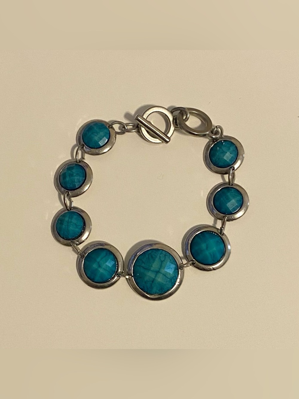 Silver tone bracelet oval faceted teal inserts